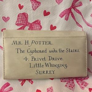 Elegant Cream Wallet with Red Emblem